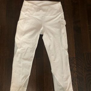 White mid-waisted cropped lululemon leggings with mesh sides